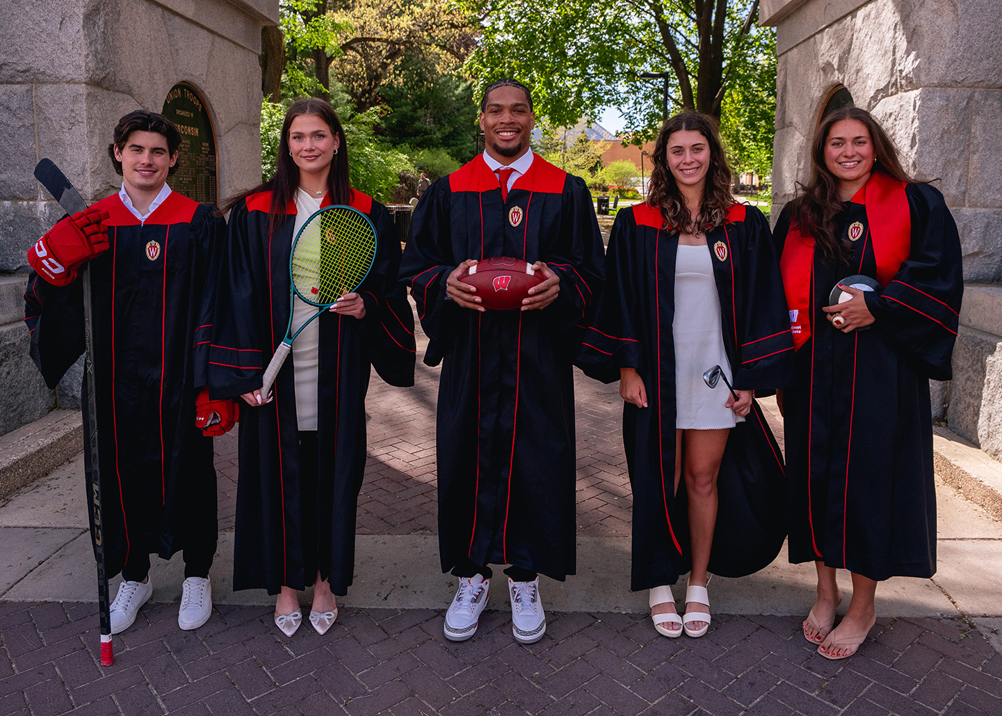A group of student athletes in graduation attire